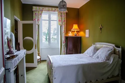 A bedroom with its own fireplace